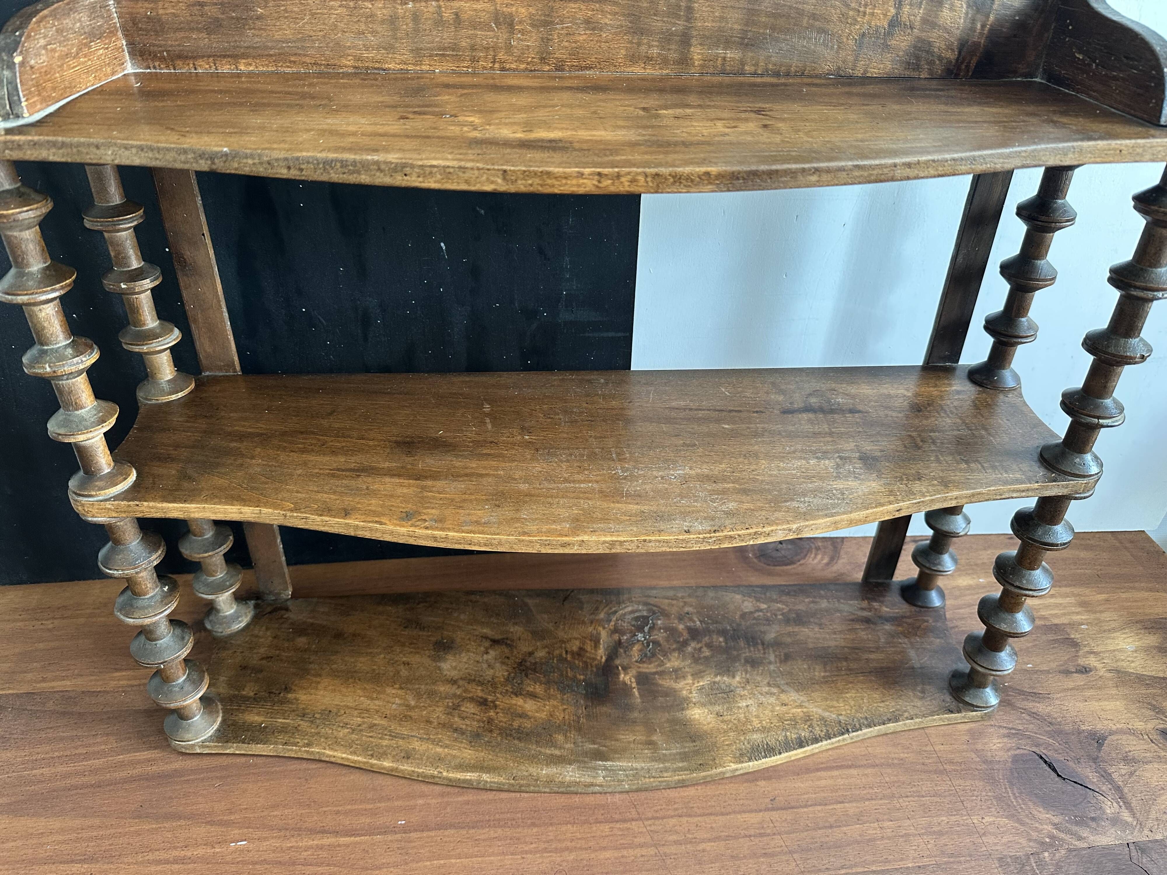 Antique wall shelf made of turned wood and spools of thread, late 19th century.
