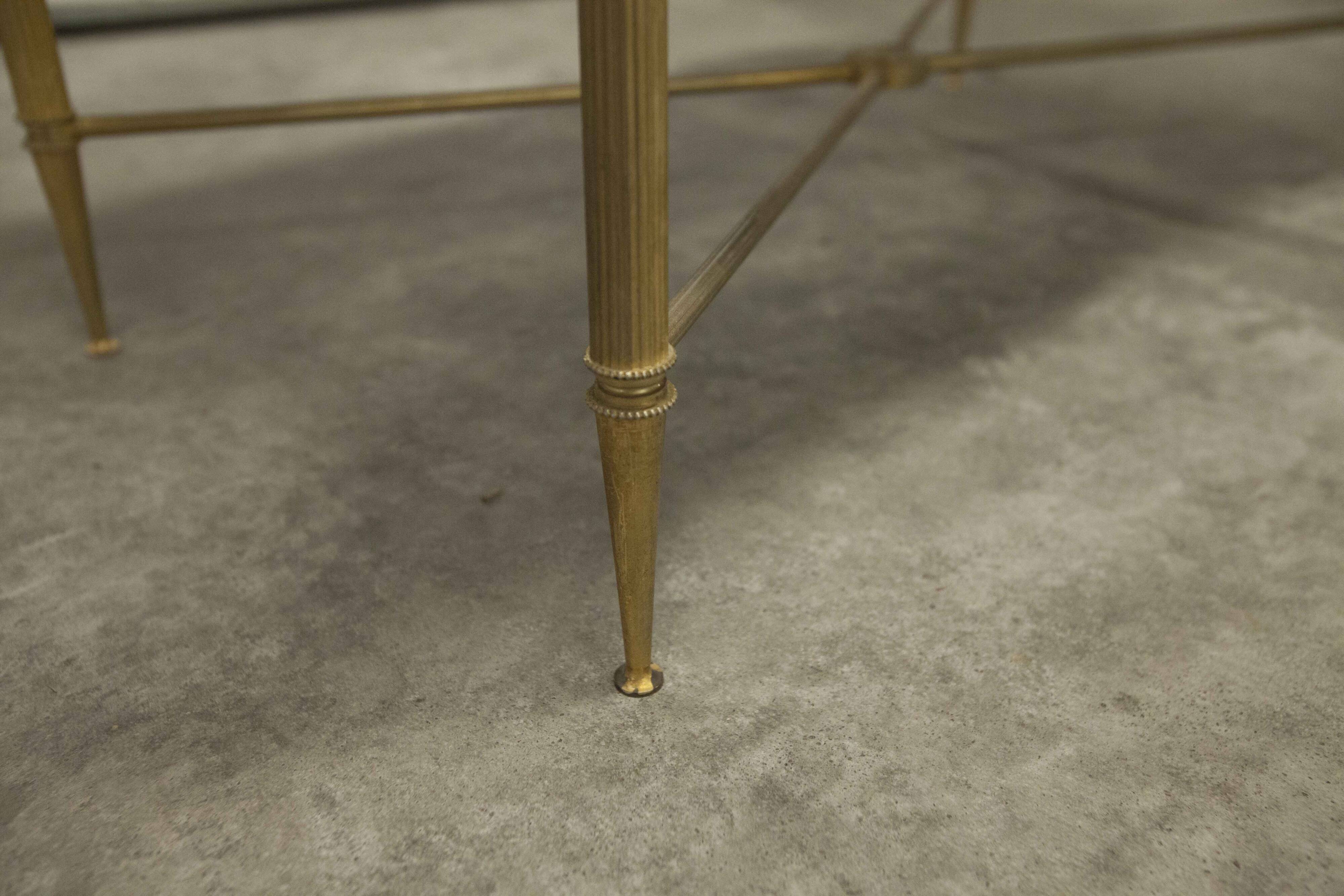 Marble coffee table with brass legs, height 46 cm.