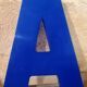 Letter A sign in vintage blue plexiglass