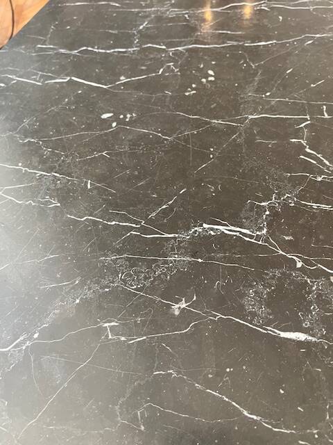 Black marble coffee table with brass legs.