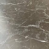 Black marble coffee table with brass legs.