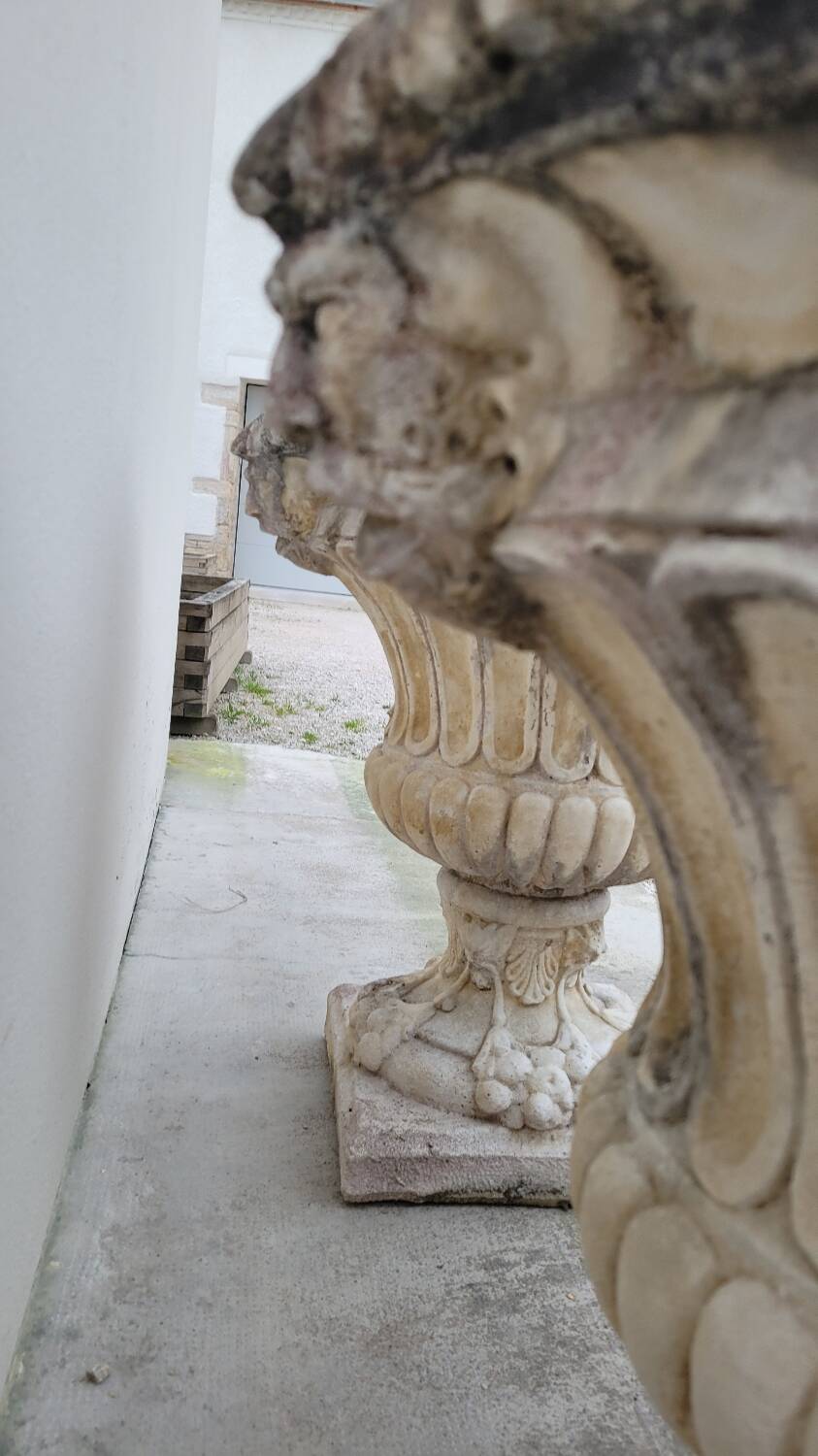 Pair of planter vases decorated with faces in reconstituted stone 1950s