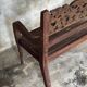 Small antique Indonesian bench in carved teak with plant and floral motifs.