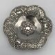 Silver-plated metal pocket emptier with openwork outline decoration