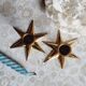 Duo of brass star candlesticks