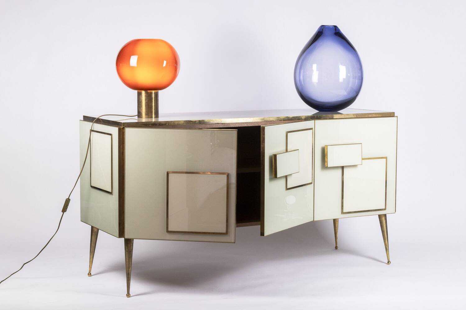 Geometric sideboard in glass and gilded brass. Contemporary Italian work.