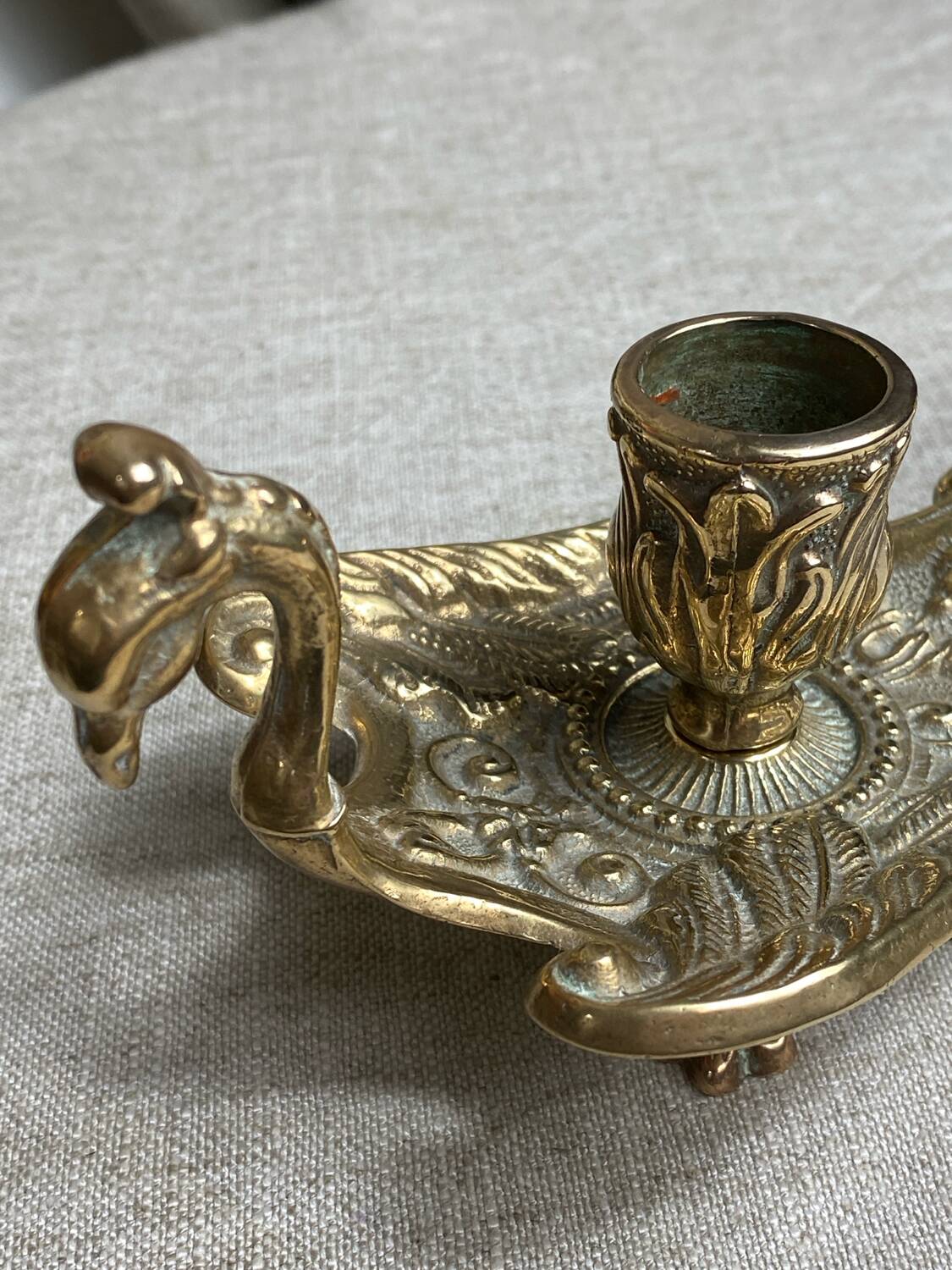 Bronze hand candlestick in the shape of a peacock