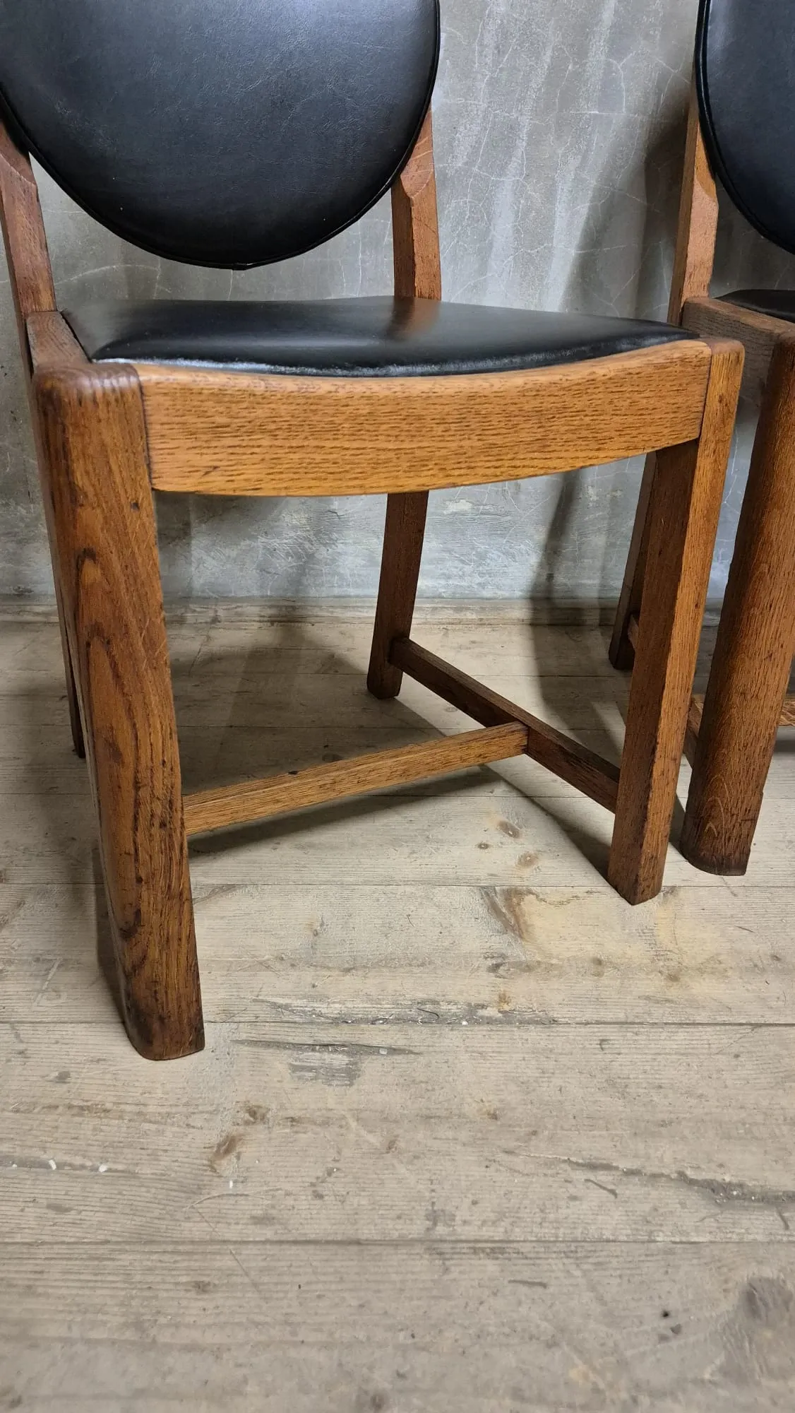 Set of four vintage wooden dining chairs with black leather upholstery, 85 × 45 × 45 cm