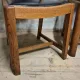 Set of four vintage wooden dining chairs with black leather upholstery, 85 × 45 × 45 cm