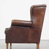 Wing chair made of sheepskin and neatly finished with black piping