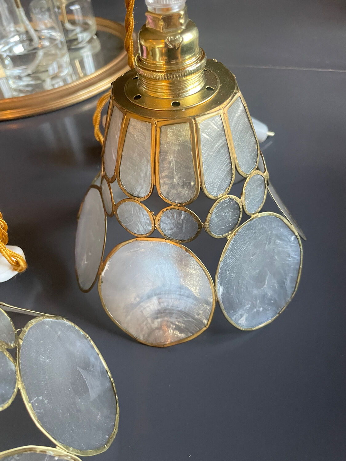 Pair of portable lamps with mother-of-pearl lampshades and brass.