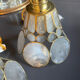 Pair of portable lamps with mother-of-pearl lampshades and brass.