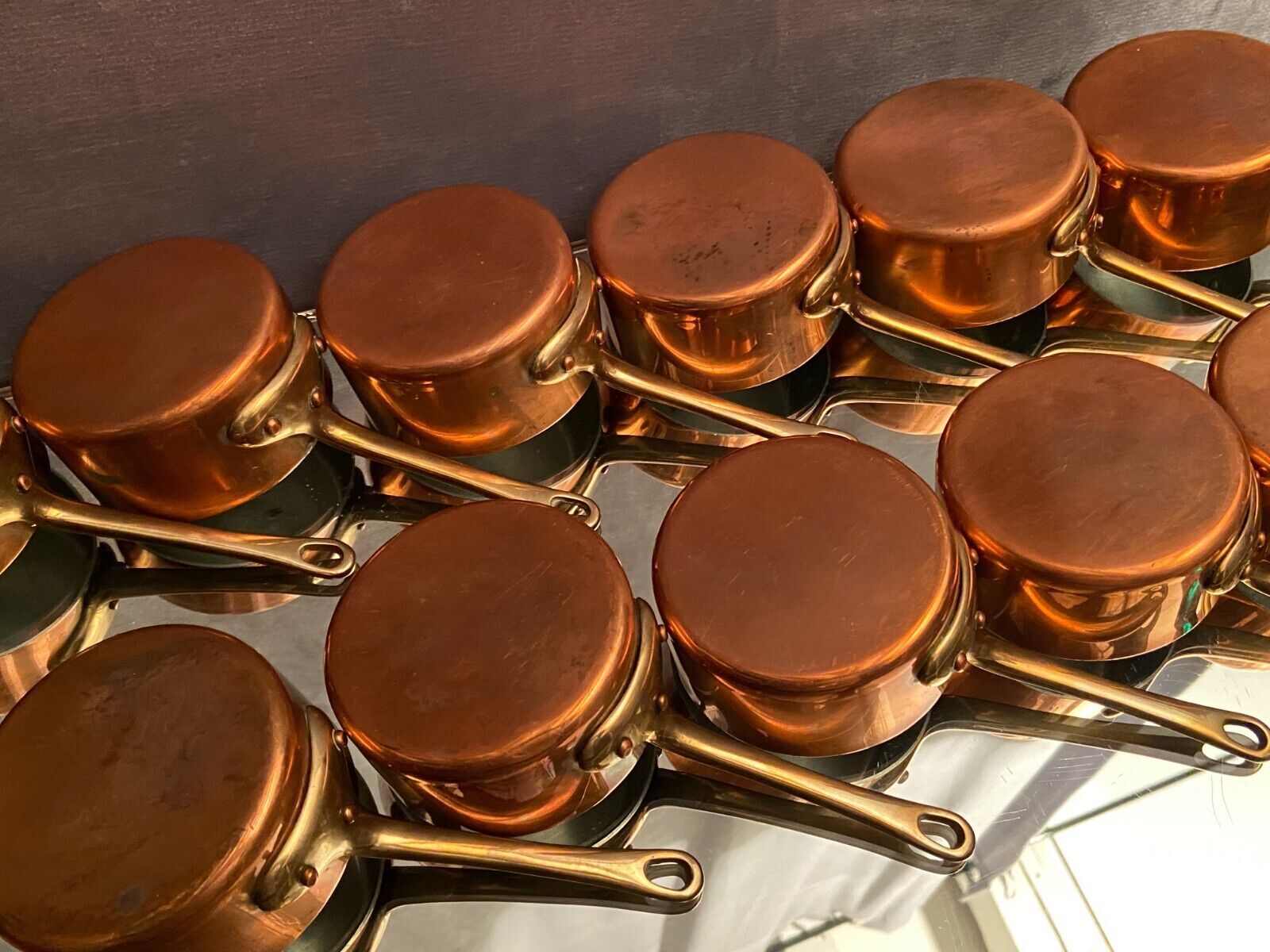 Suite of 12 tinned copper pans