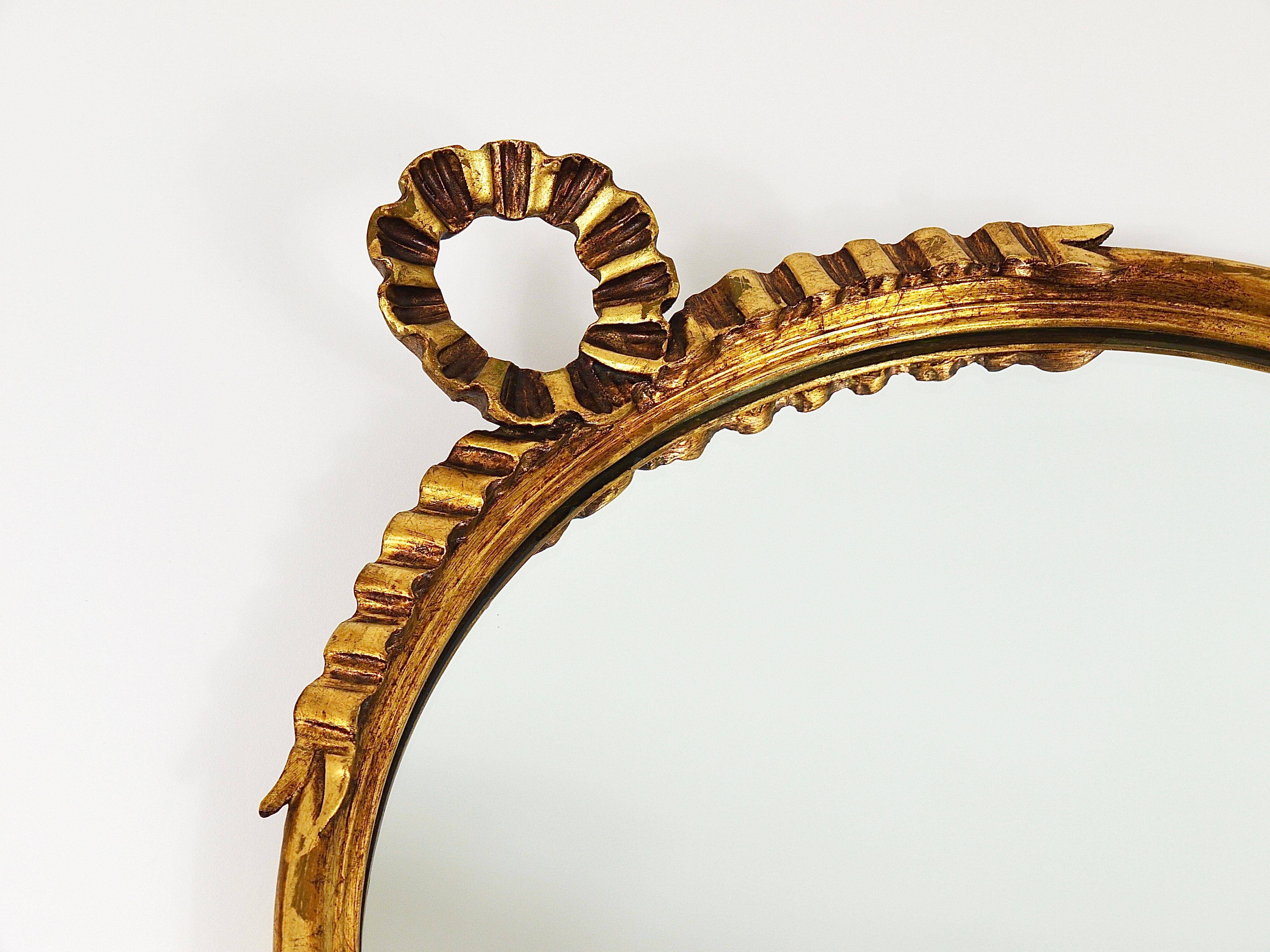 Round wall mirror in gilded wood, mid-century, C. Allodi & G. Subelli, Italy, 1950s.