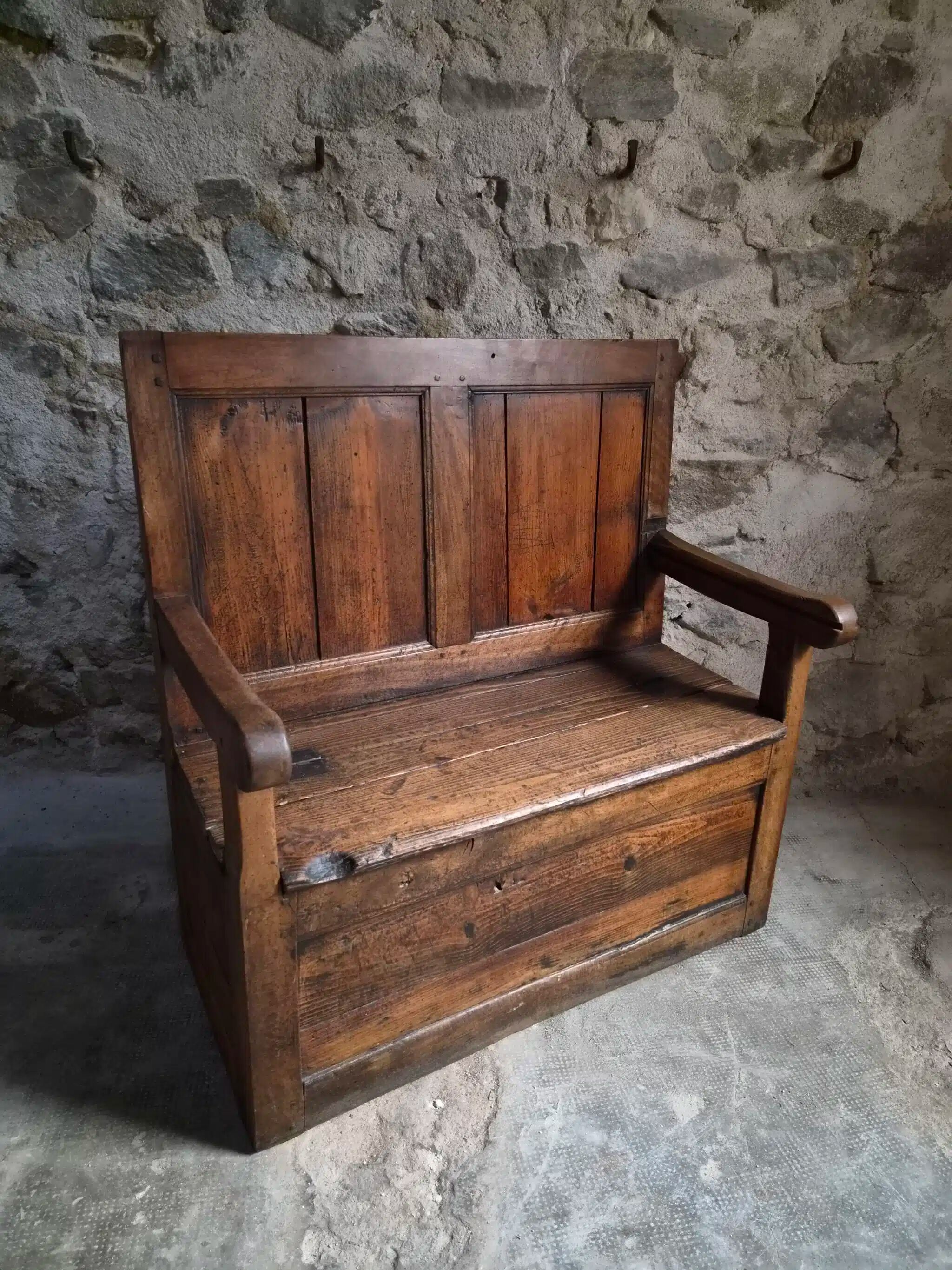 Rustic French antique storage bench from the 18th century in walnut and pine.