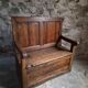 Rustic French antique storage bench from the 18th century in walnut and pine.