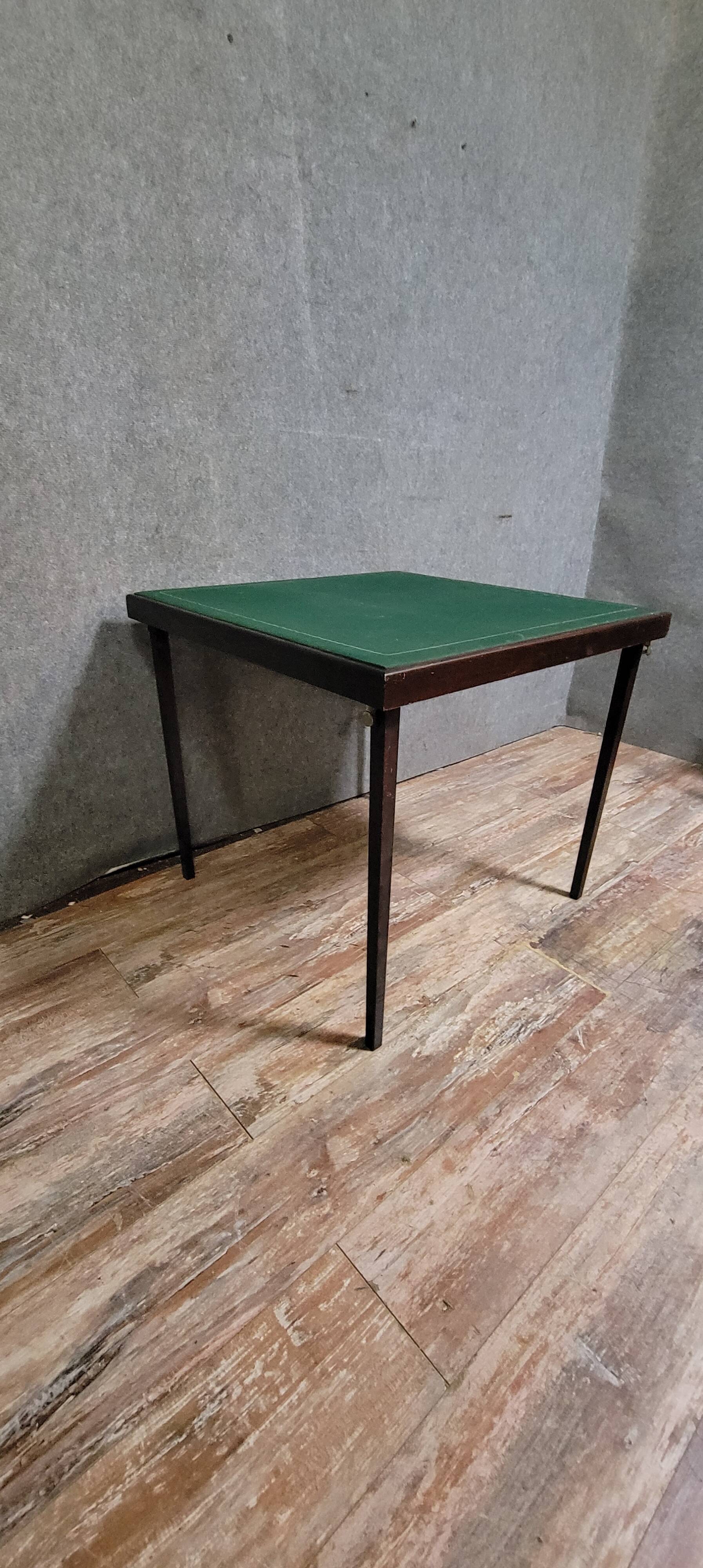 a wooden Bridge game table resting on four thin, straight legs