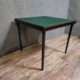 a wooden Bridge game table resting on four thin, straight legs