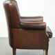Subtle sheepskin wingback armchair with a deep cognac colour