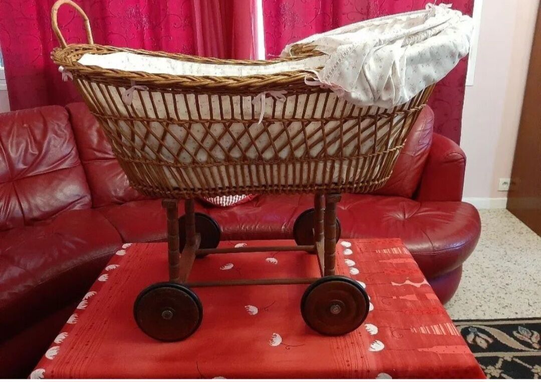Vintage wicker cradle on wheels from the 1970s.