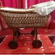 Vintage wicker cradle on wheels from the 1970s.