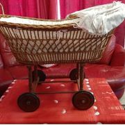 Vintage wicker cradle on wheels from the 1970s.