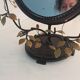 Table mirror, tilting psyche in patinated bronze decorated with leaves and fruits