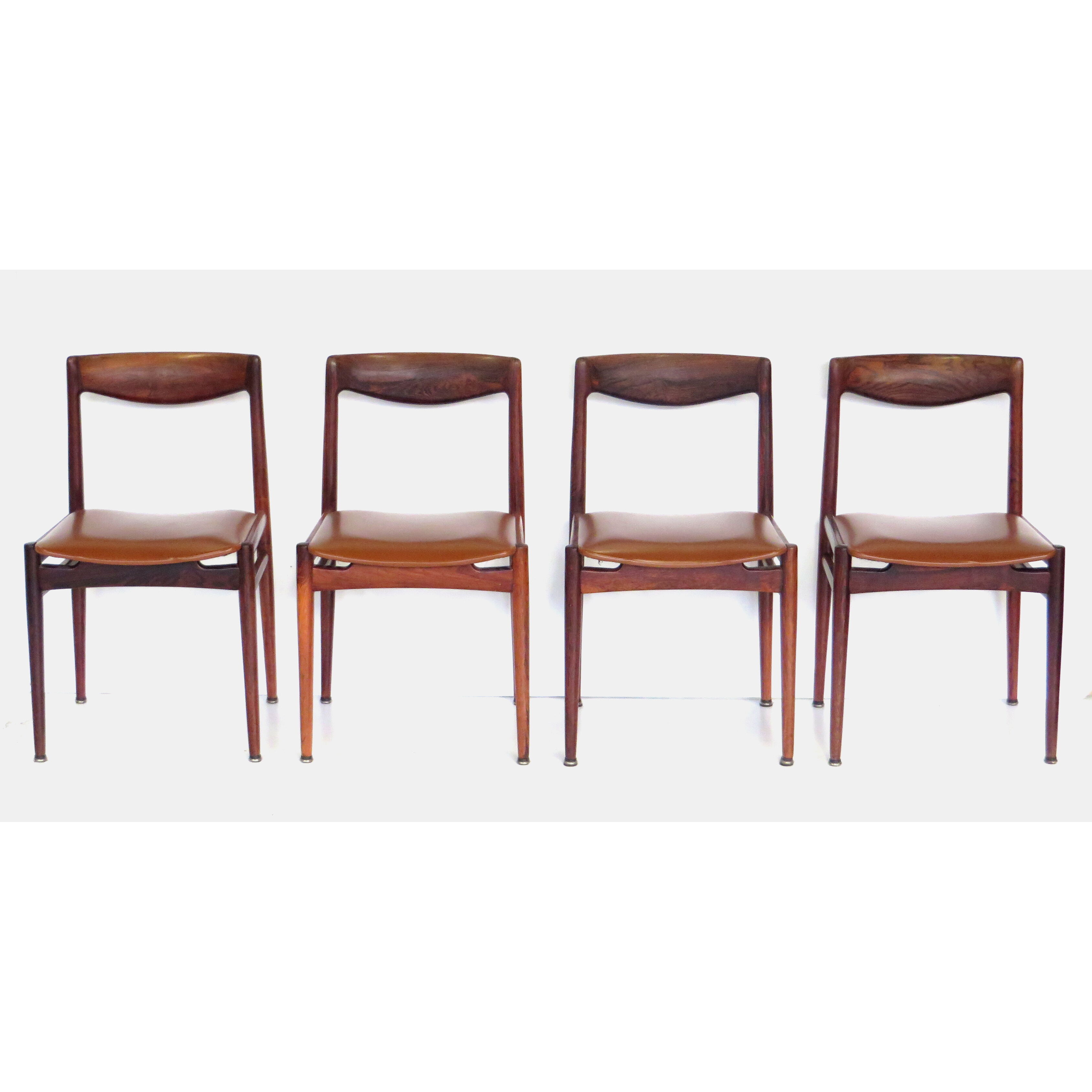 Set of four vintage mid century rosewood dining chairs with cognac leather seats