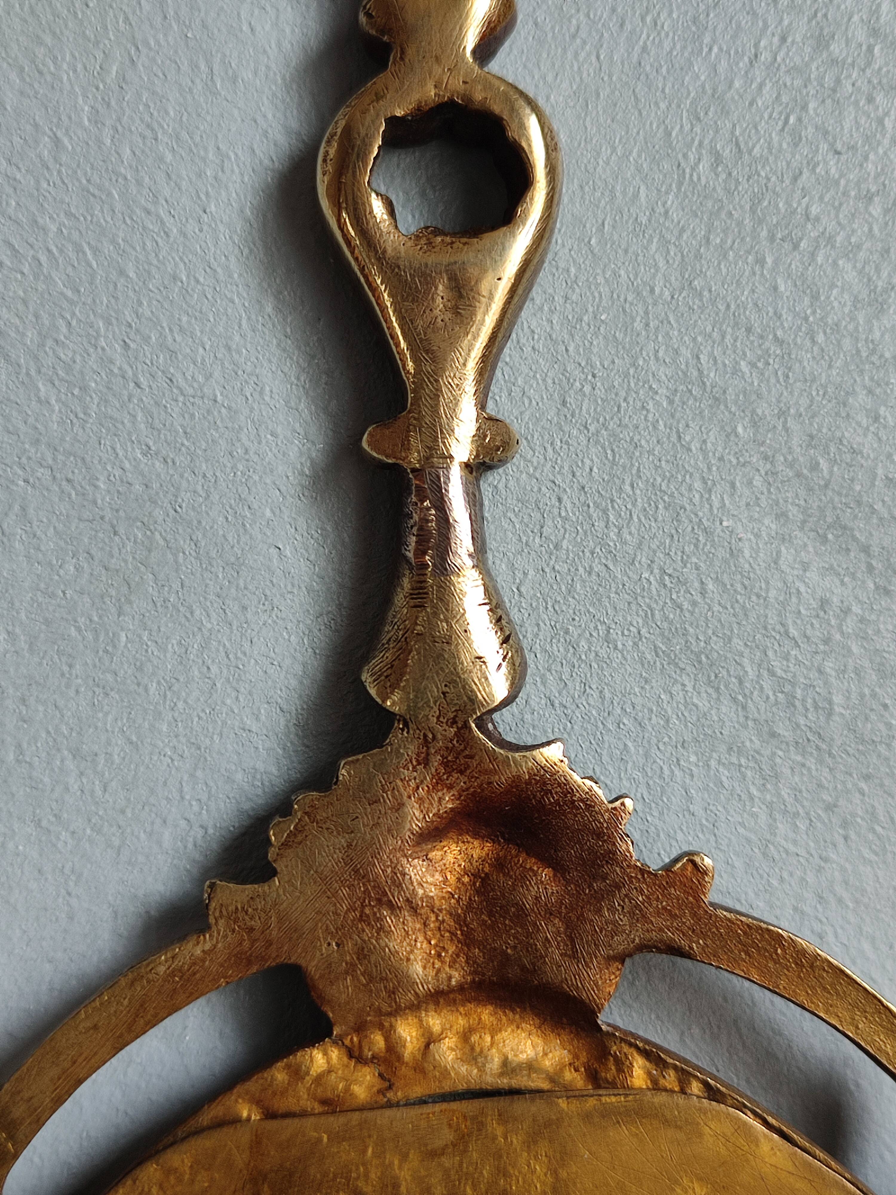 Antique hand-facing mirror in bronze and beveled glass