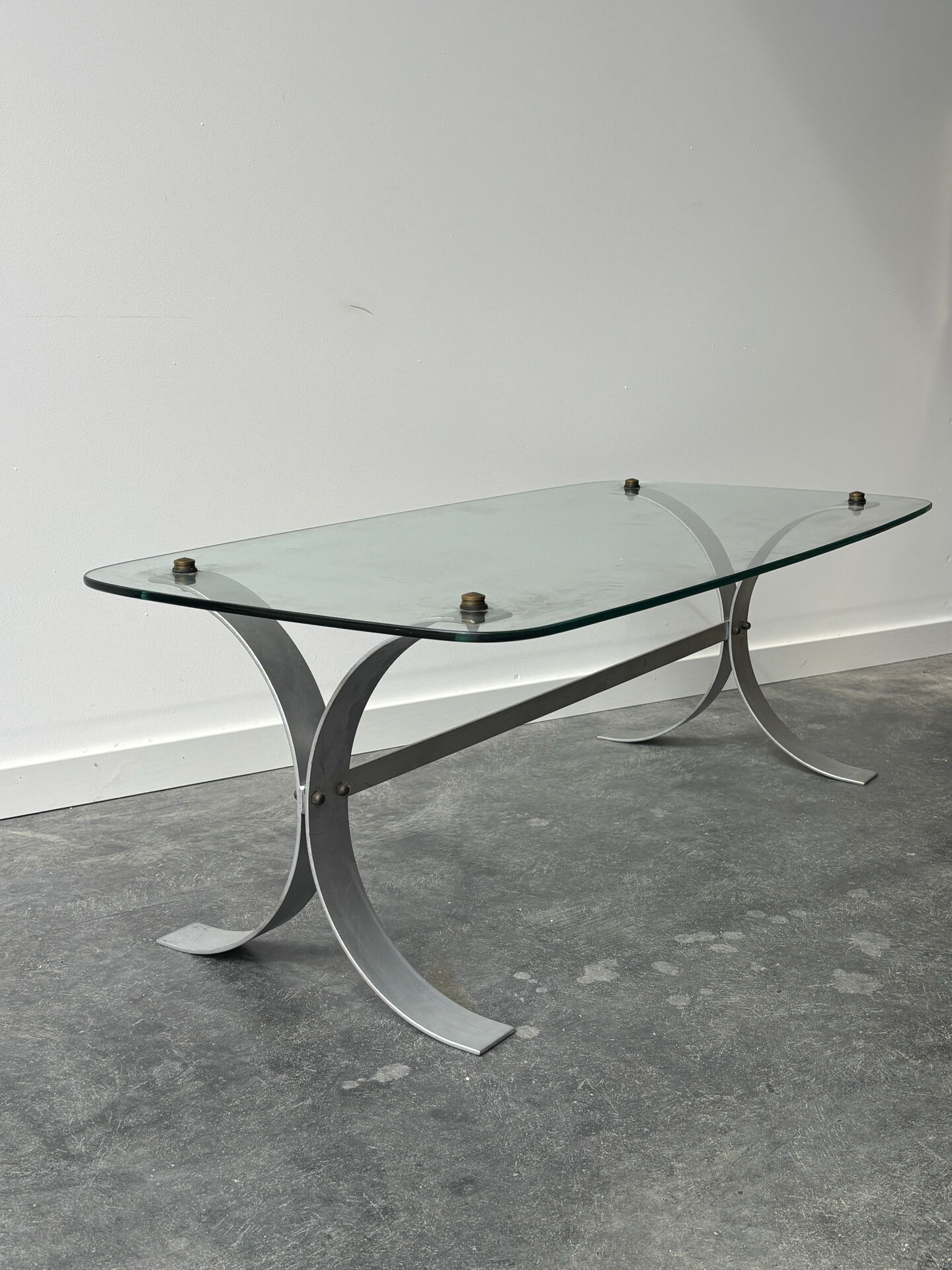 Design coffee table in brushed metal with a glass top, 1970s.