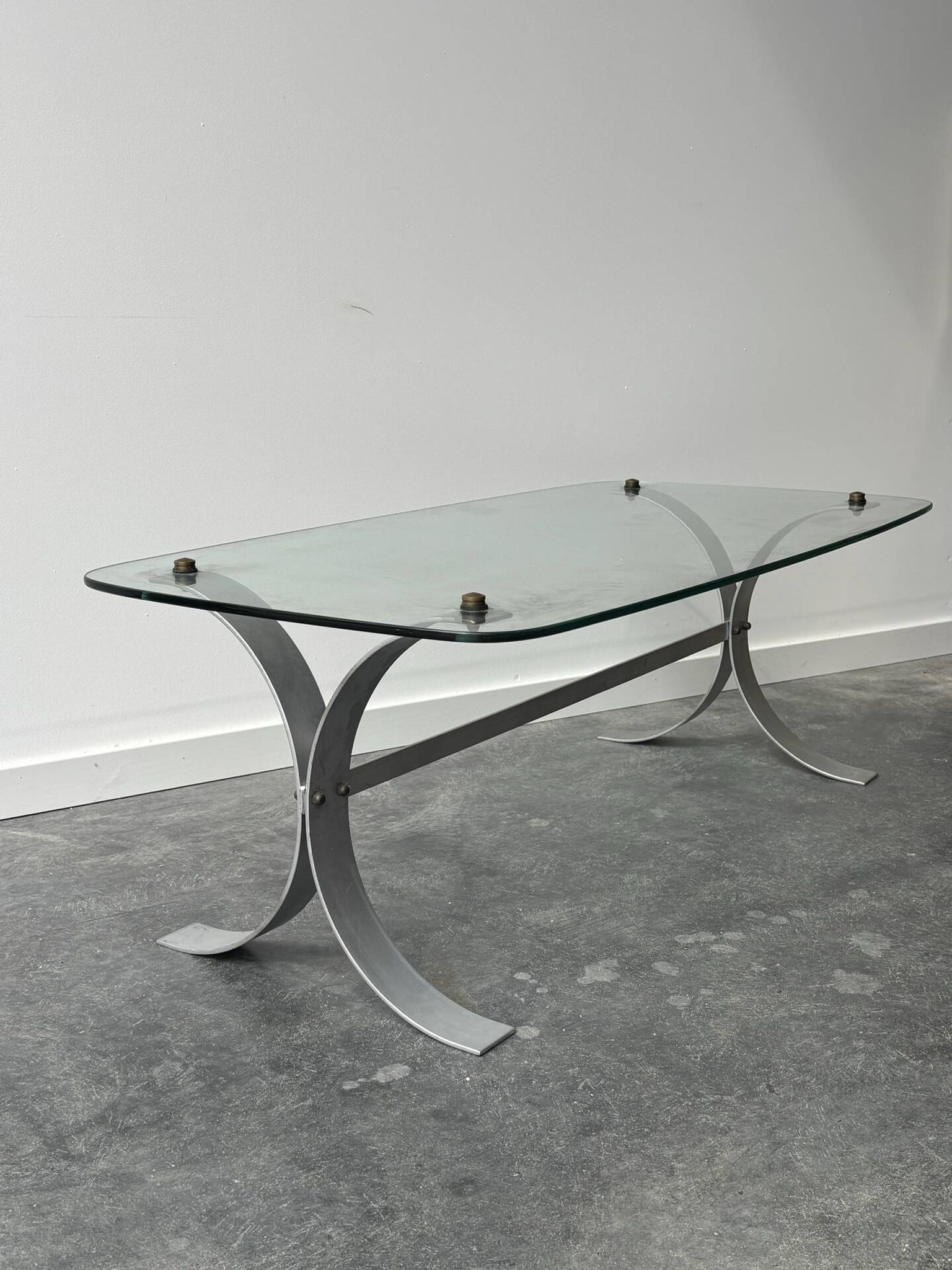 Design coffee table in brushed metal with a glass top, 1970s.
