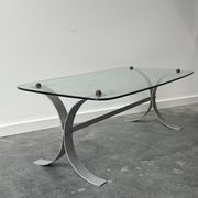 Design coffee table in brushed metal with a glass top, 1970s.