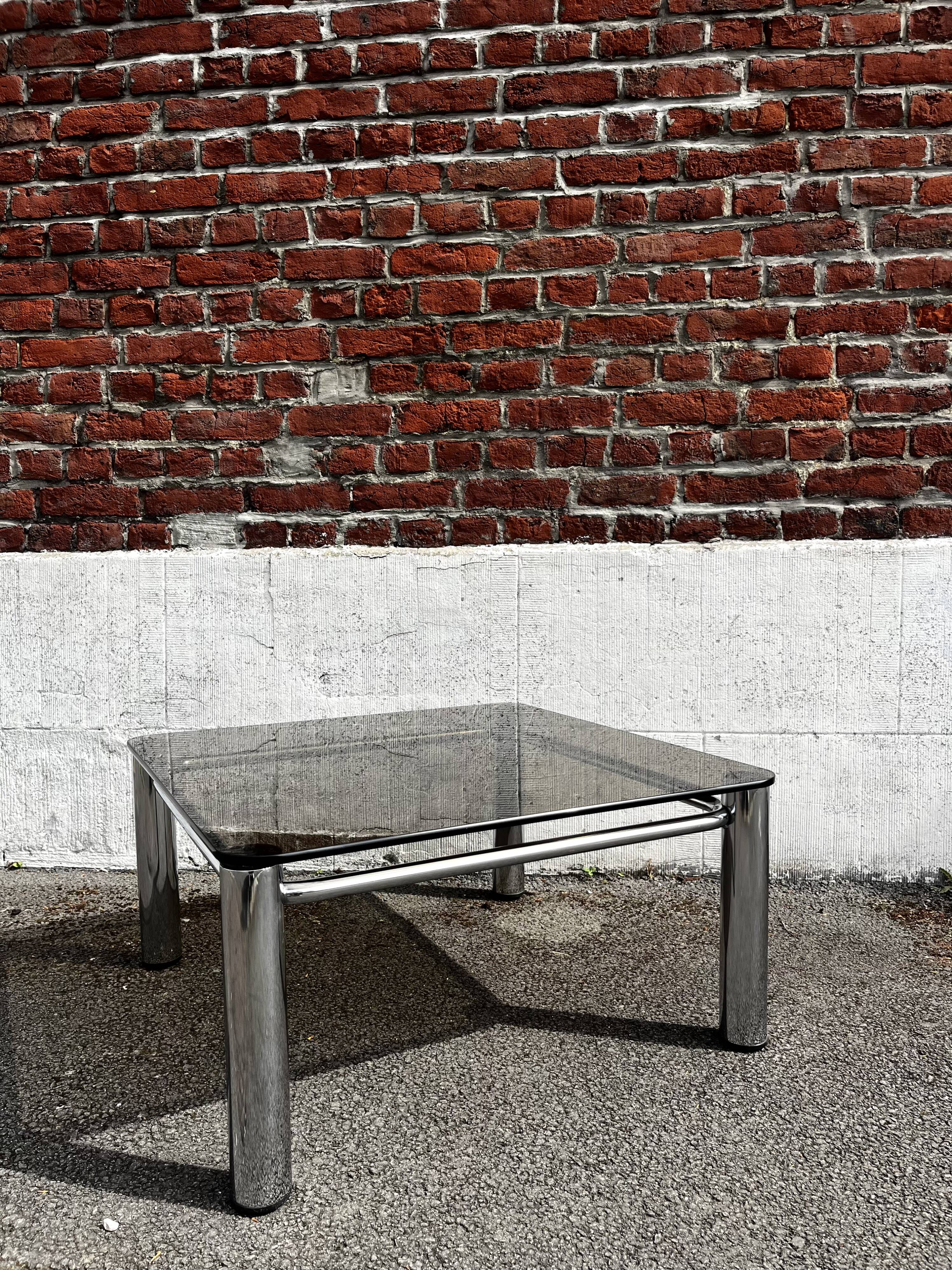 Vintage smoked glass coffee table with chrome structure.