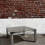 Vintage smoked glass coffee table with chrome structure.