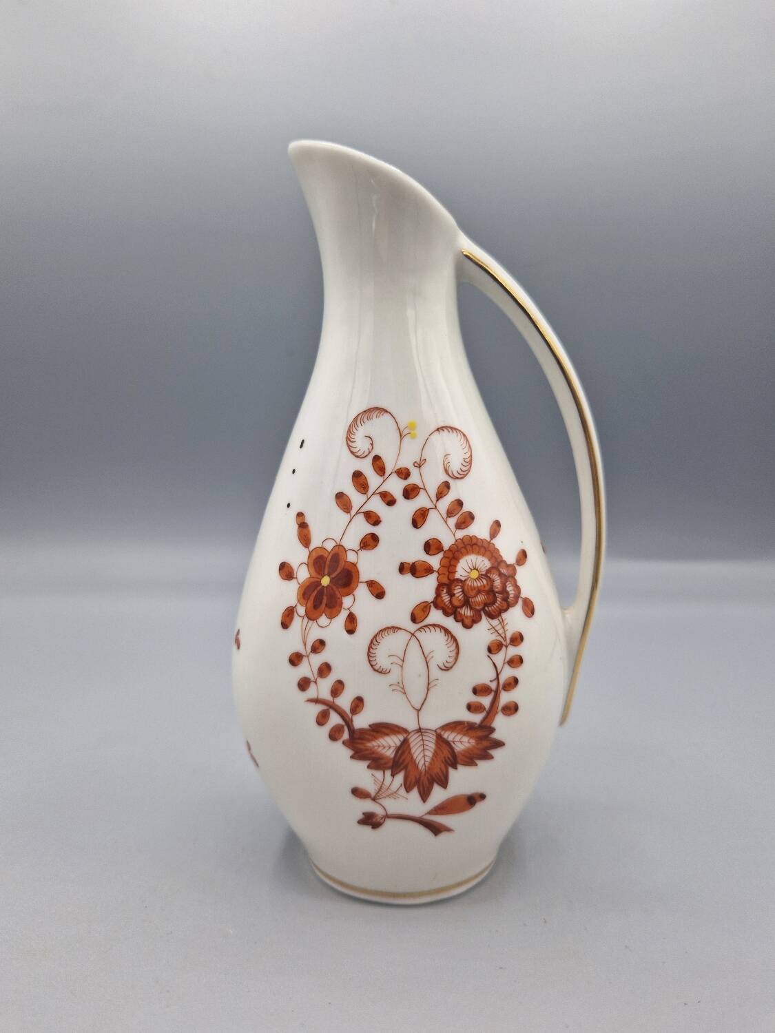 Hand painted German porcelain pitcher with floral design and gold trim