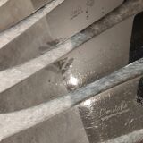 12 silver-plated table knives, Christofle goldsmith ribbons