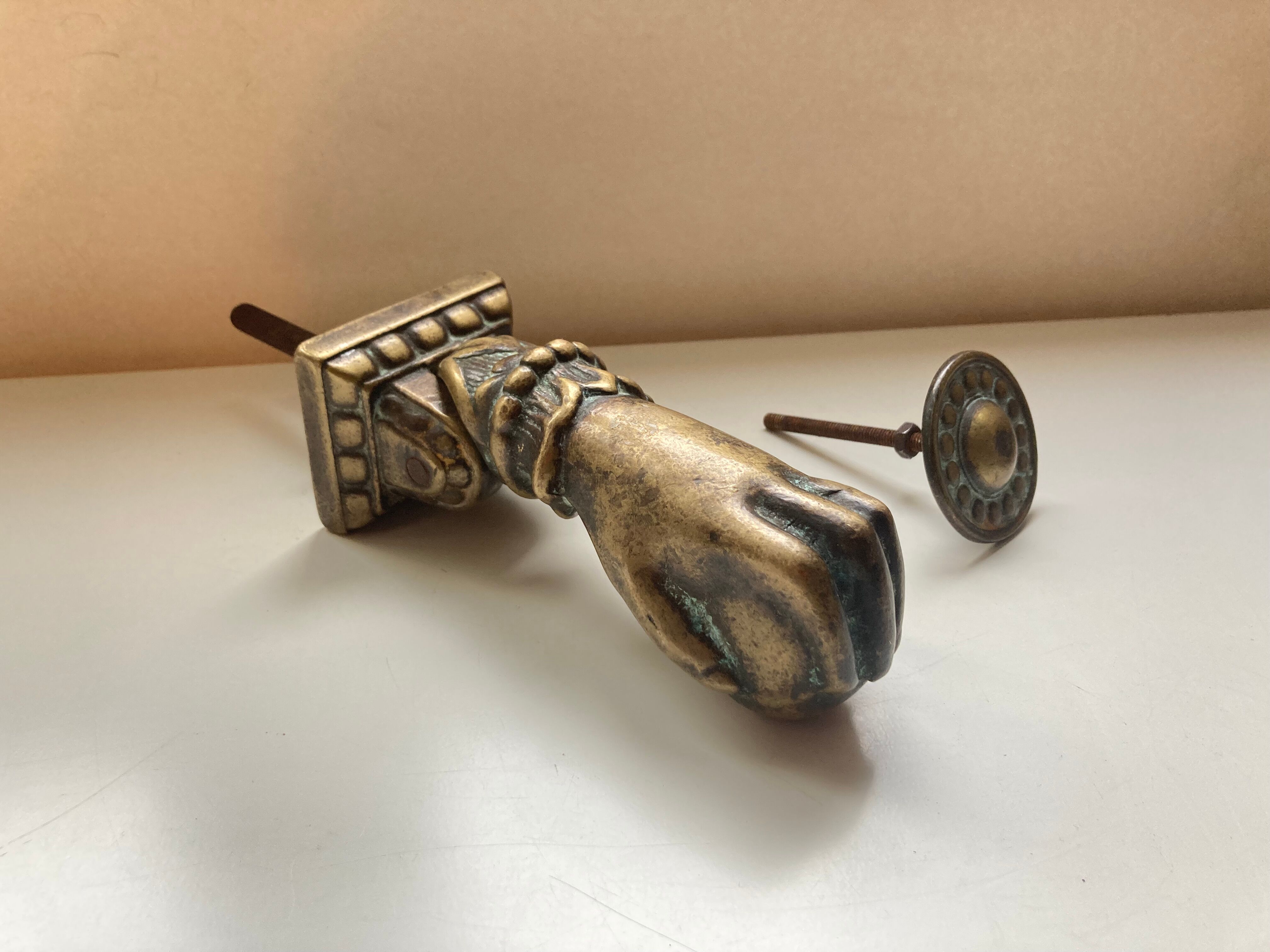 Antique bronze hand-shaped door knocker