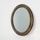Miroir ovale néoclassique français en noir et or, 20e siècle