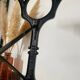 Bistro table with iron legs and raw wood top.