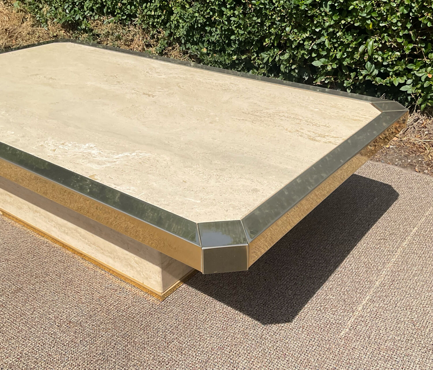 Vintage coffee table in travertine and brass.