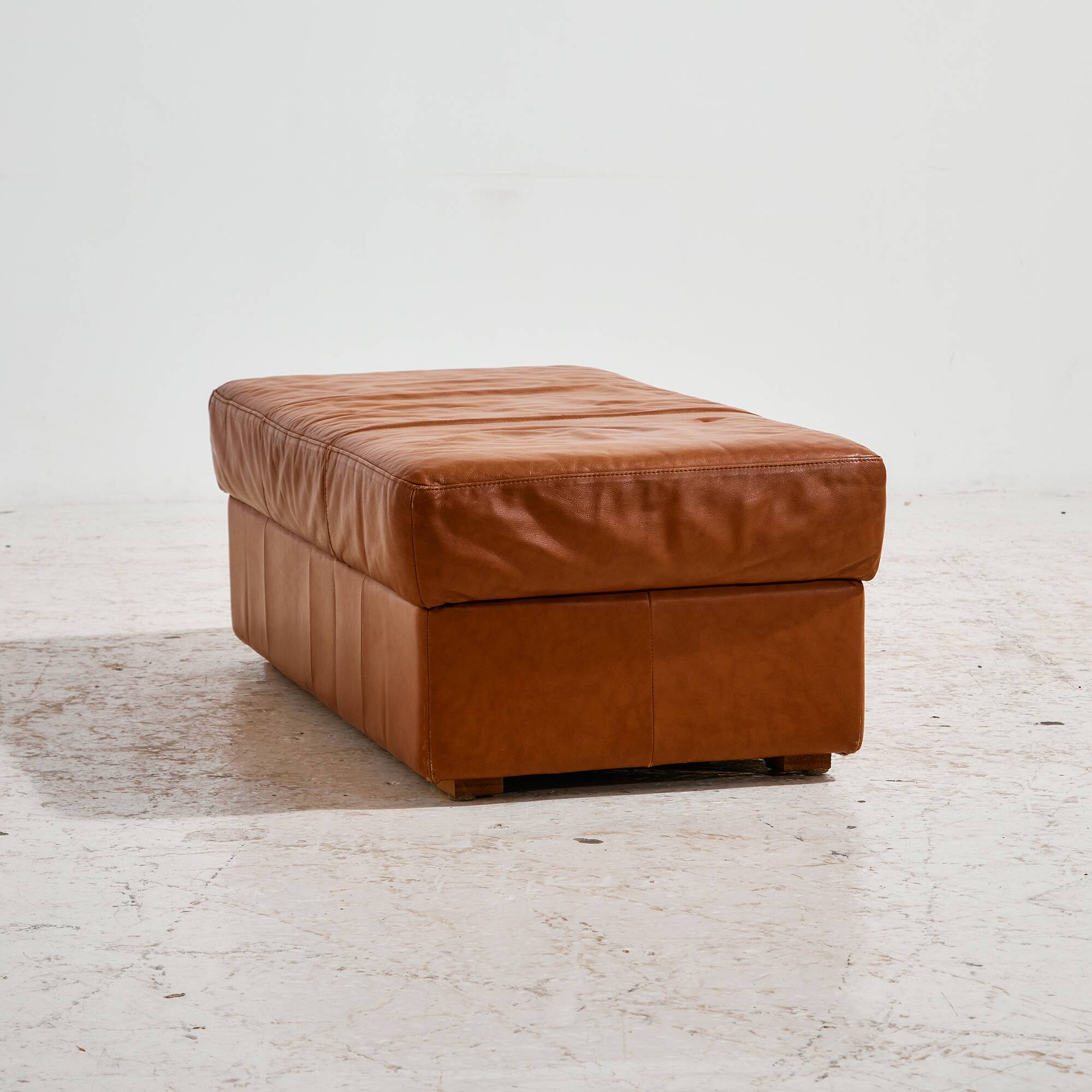 Ottoman with leather upholstery