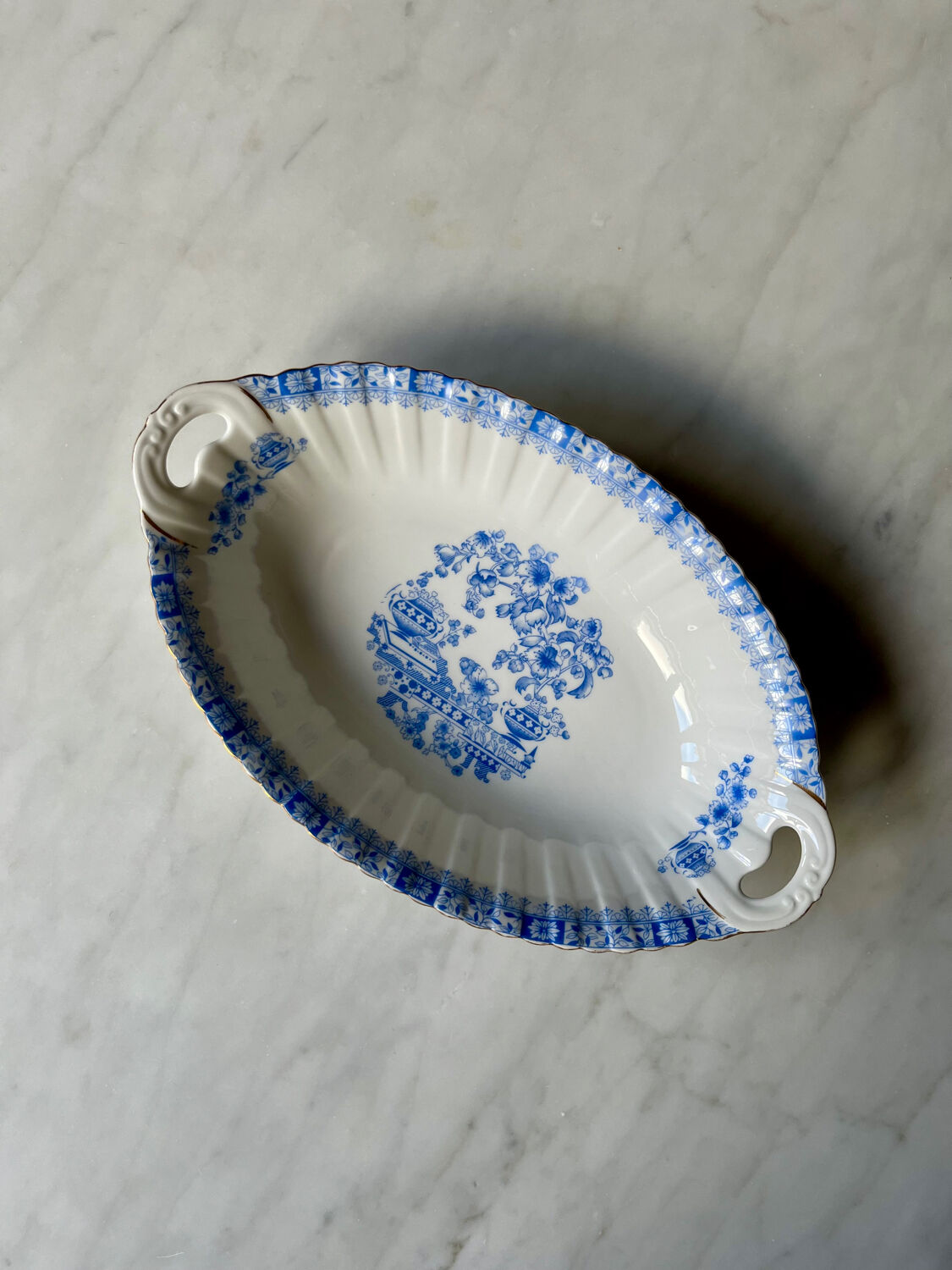 Antique oval dish with handles in earthenware