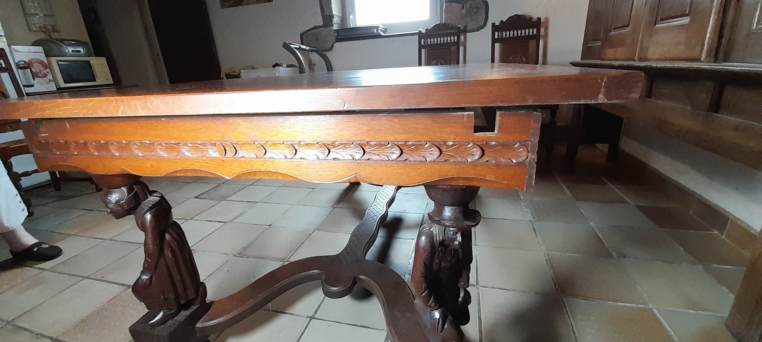 Breton dining room table with 2 extensions and 6 chairs with carved Breton characters