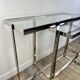 Chrome metal and glass console from the 2000s.