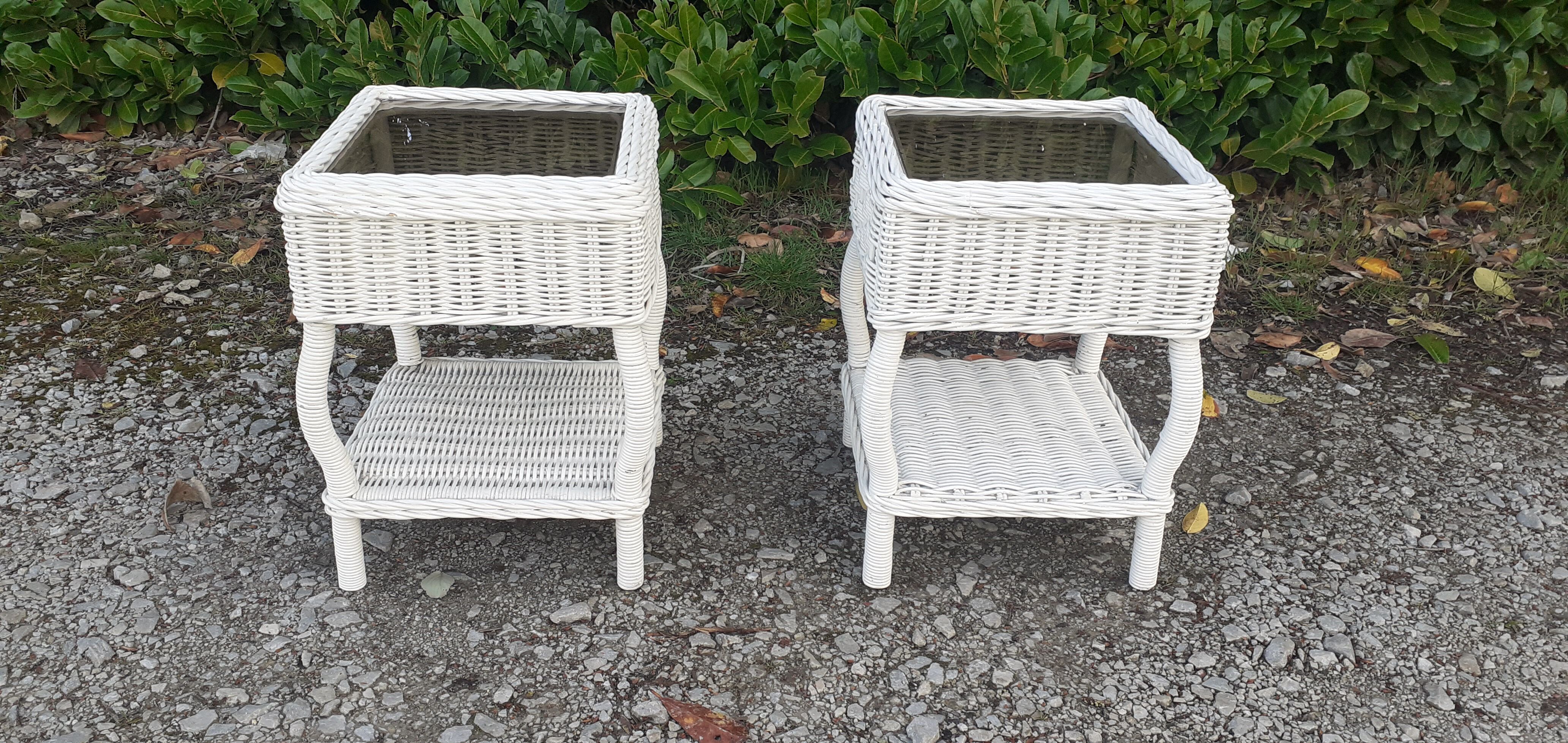 Pairs of white rattan side tables and smoked glass