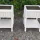 Pairs of white rattan side tables and smoked glass