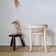 Vintage curved wooden stool in Baumann style, striped fabric seat.