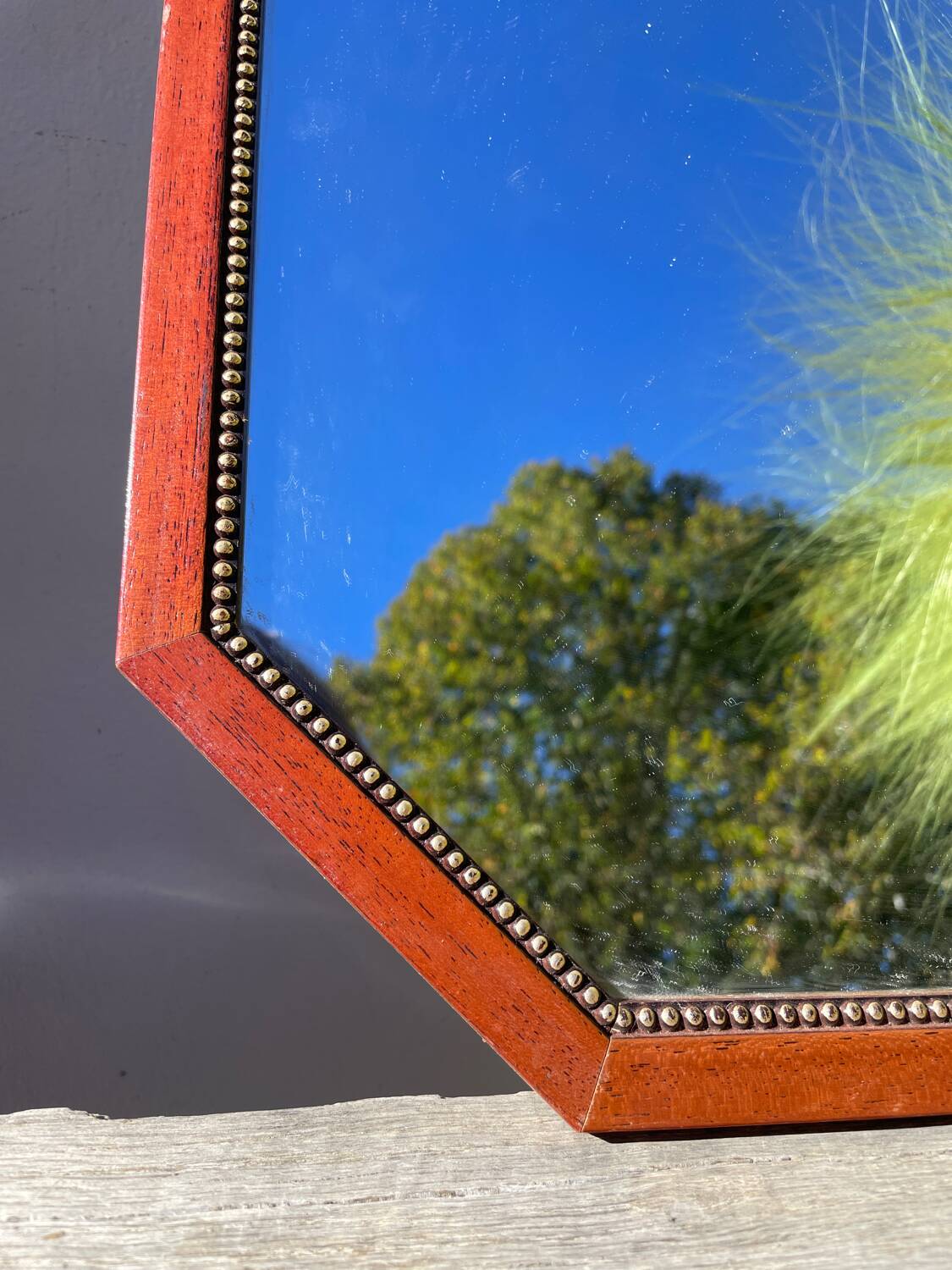 Octagonal beaded wooden mirror