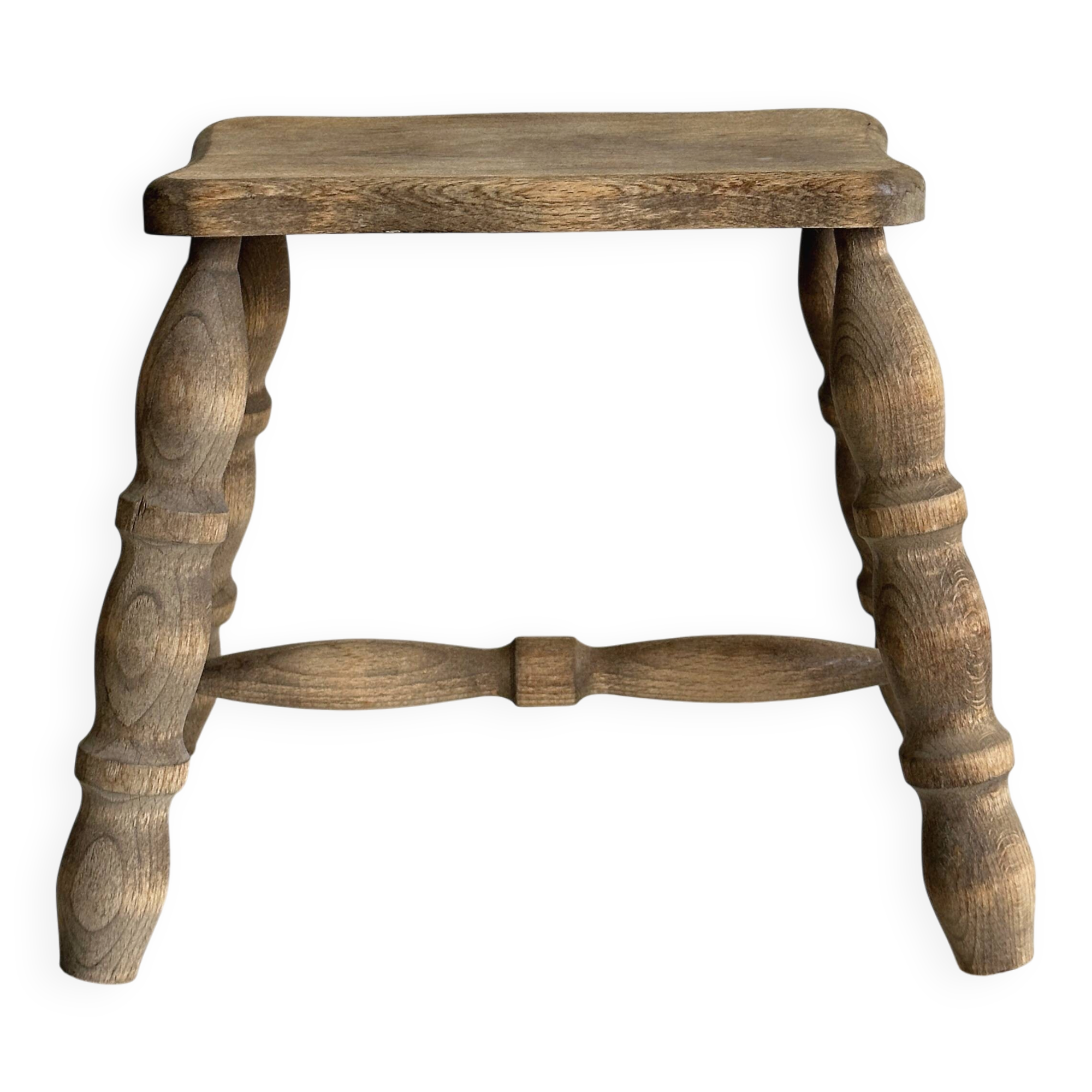 Antique wooden stool with four turned legs.