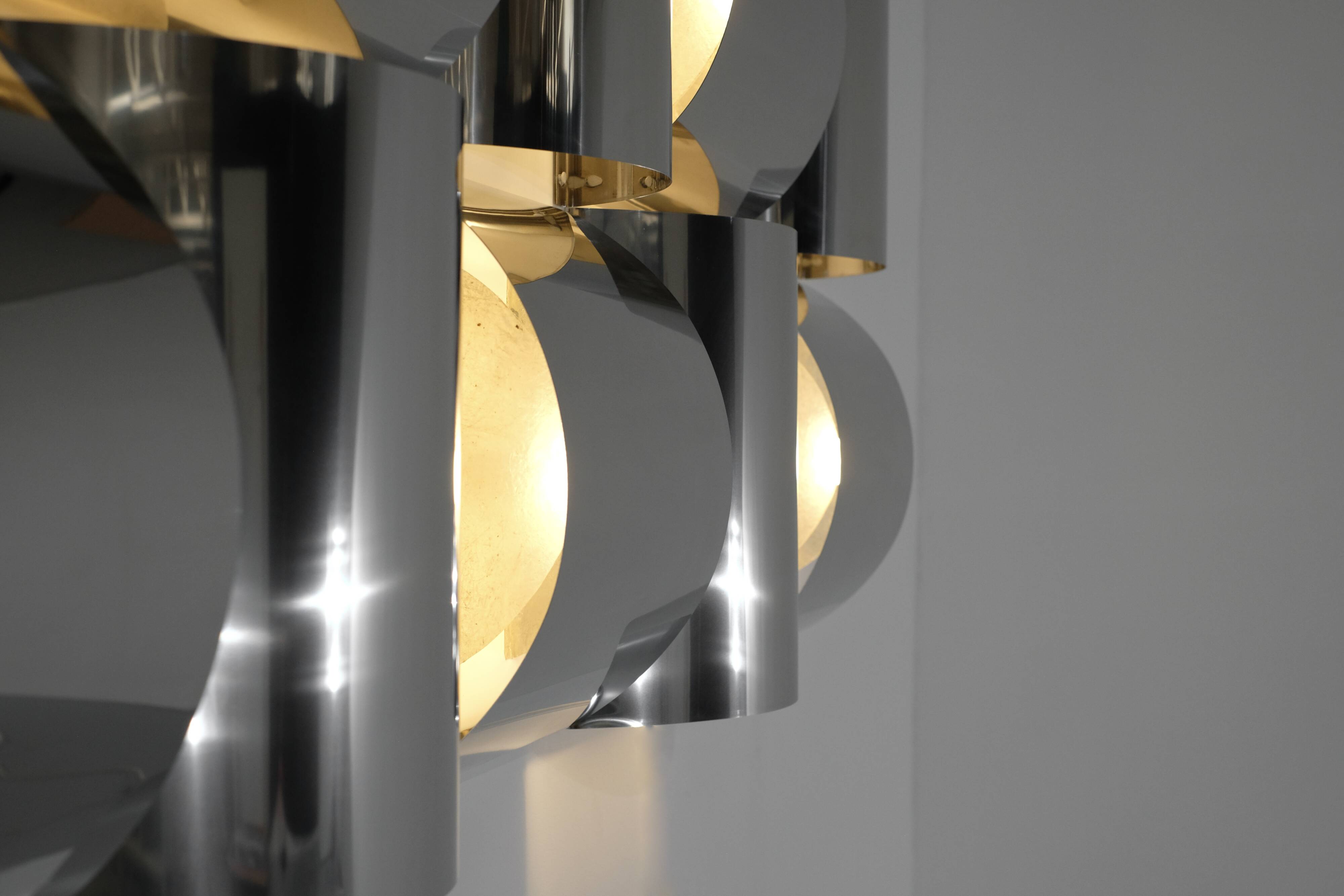 Contemporary wall light in stainless steel and metal.